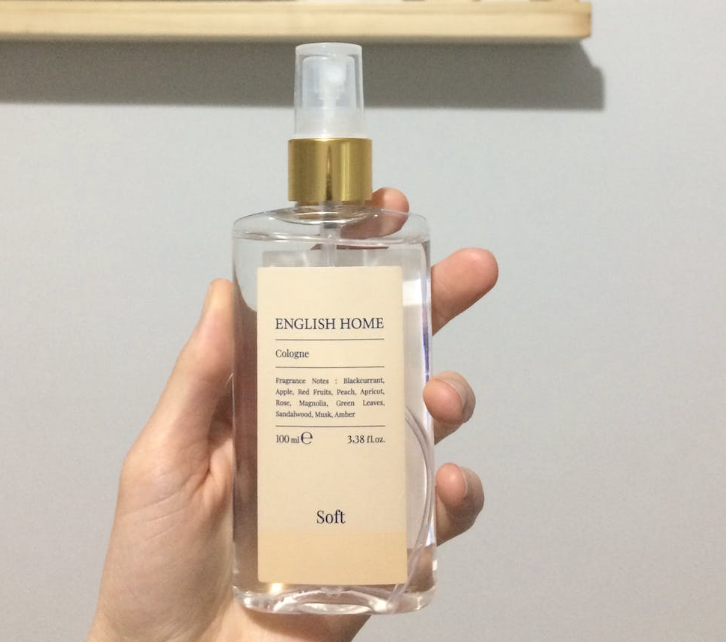 someone holding a 100 oz or 3.4 mL bottle of a fragrance called English Homme
