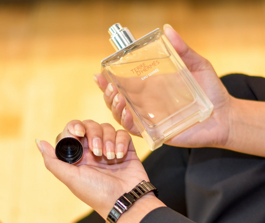 person holding a bottle of Terre d'Hermès Parfum