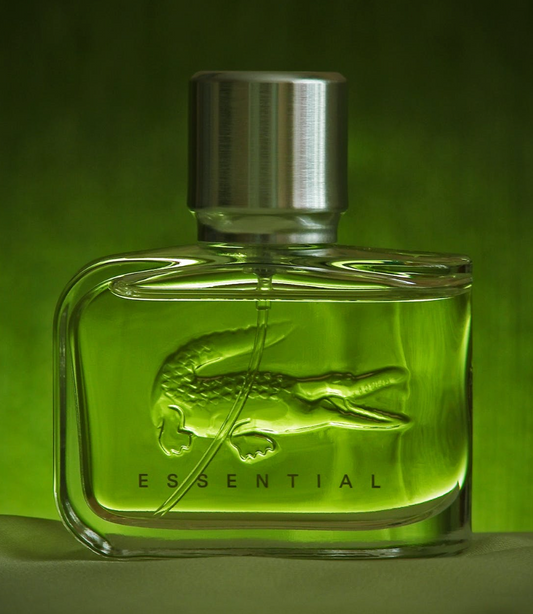 bottle of lacoste essential cologne in green bottle with a silver cap