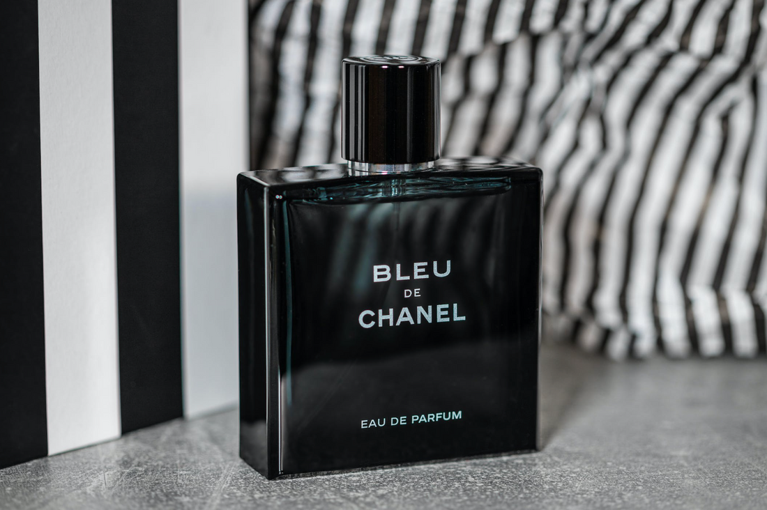 capped bottle of bleu de chanel eau de parfum cologne in front of a black and white background