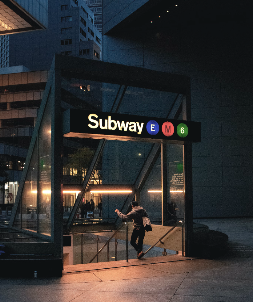 a man taking the stairs down to new york subway