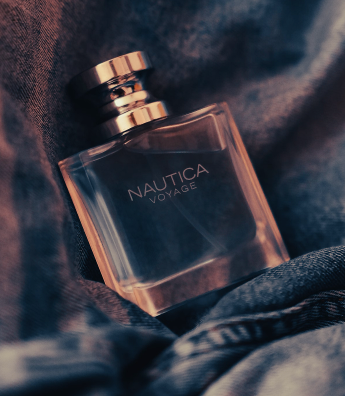 bottle of 2007 vintage nautica voyage cologne laying on top of denim