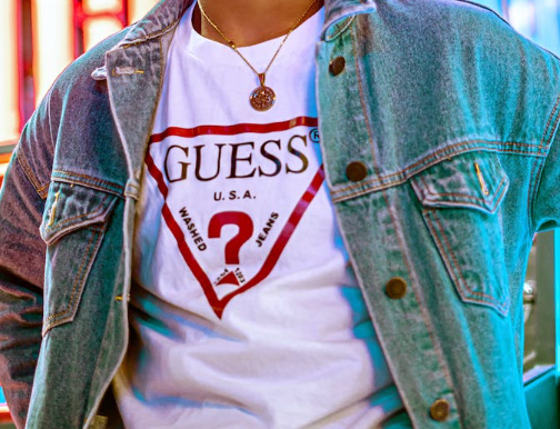 photo of a man wearing a guess brand t-shirt under a jean jacket