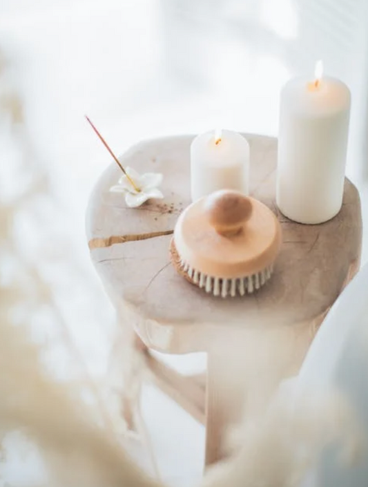 white candles and incense placed on a stool