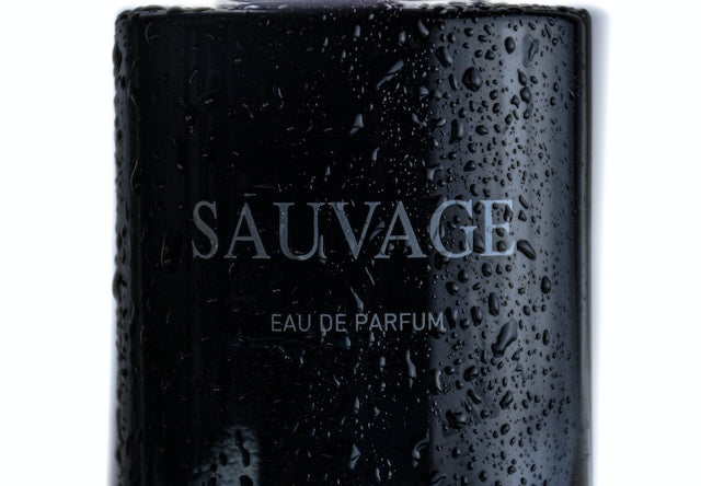 wet black bottle of dior sauvage eau de parfum cologne