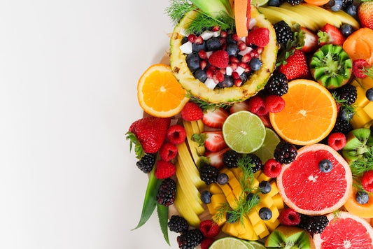 an assortment of juicy fruits including grapefruit, lemons, strawberry, and raspberry