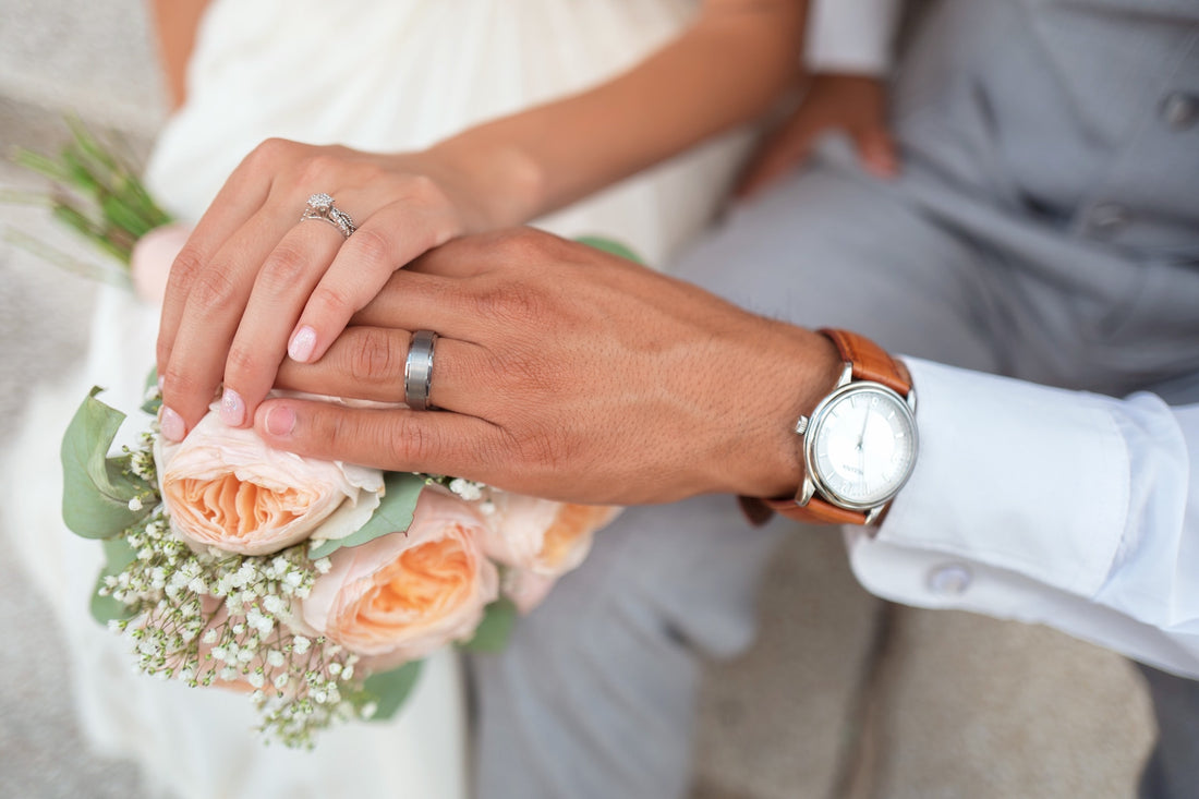 a woman's and man's hands locked together during their wedding day