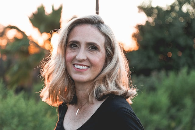 photo of smiling mature woman standing outdoors