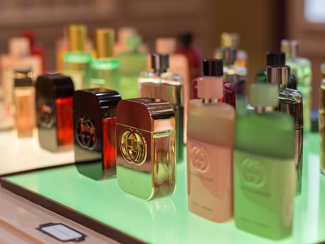 several gucci perfume bottles spaced out in a multi-colored area