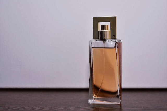 bottle of unbranded perfume with gold cap and sprayer