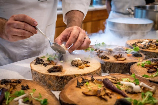 Chef Preparing Vegetable Dishes on Tree Slabs