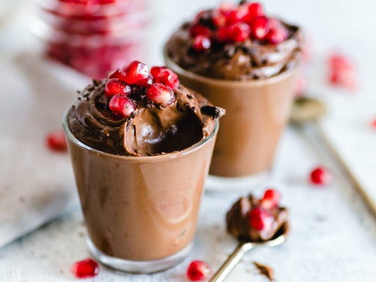 close-up photo of chocolate mousse in 2 small cups