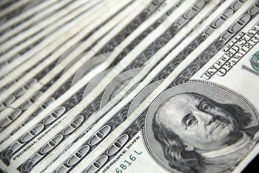 several 100 dollar bills lined up together