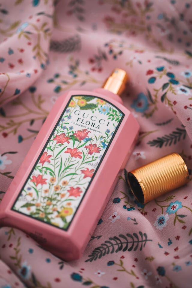 close-up of a pink bottle of gucci flora jasmine based perfume